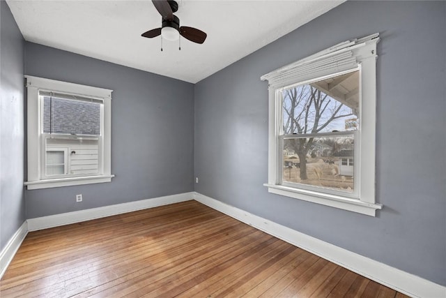 unfurnished room featuring ceiling fan, baseboards, and hardwood / wood-style flooring