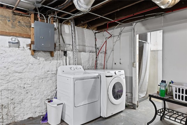 clothes washing area with laundry area, electric panel, and washing machine and clothes dryer