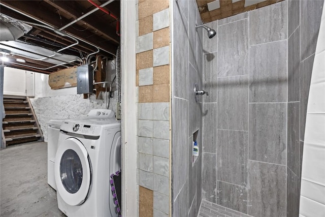 clothes washing area featuring laundry area, electric panel, and washer / clothes dryer