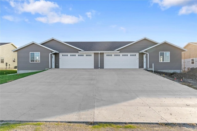 ranch-style home featuring a garage and driveway