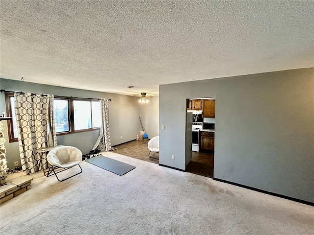 unfurnished bedroom with carpet, baseboards, and a textured ceiling