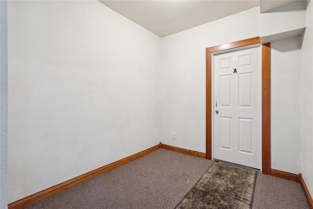 unfurnished room featuring carpet floors and baseboards