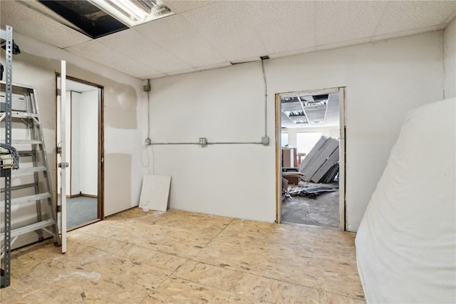 basement featuring a drop ceiling