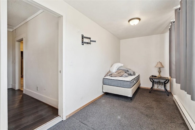 sitting room featuring a baseboard heating unit and baseboards