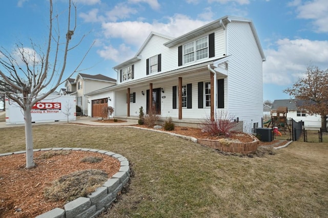 view of front of home with central AC unit, concrete driveway, covered porch, fence, and a front yard