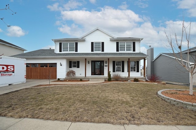 view of front of home with a garage, a front yard, covered porch, and driveway