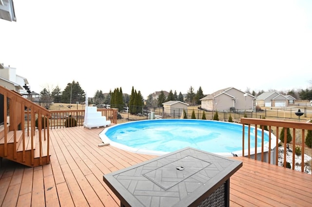 view of swimming pool with a fenced backyard, a fenced in pool, and a wooden deck