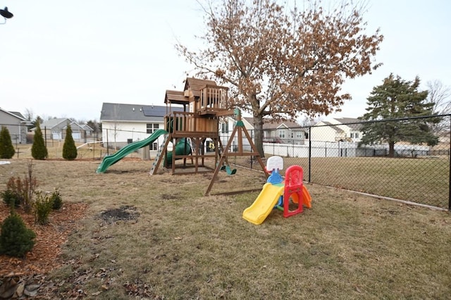 community playground featuring a yard, a residential view, and fence