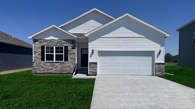 view of front of house with an attached garage, driveway, and a front lawn