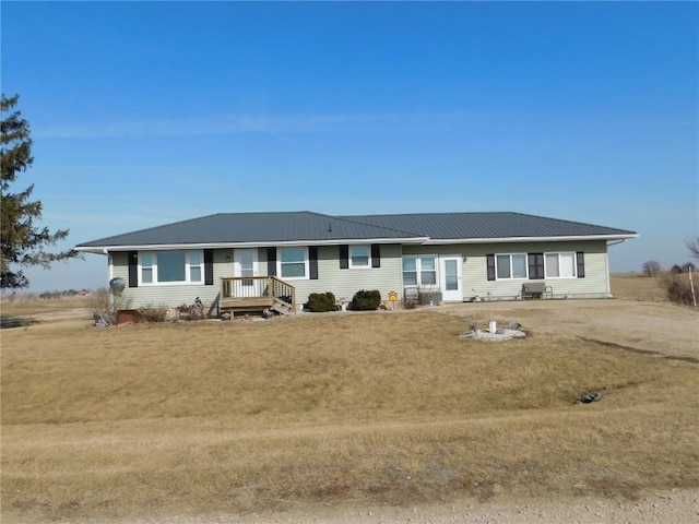 ranch-style house with metal roof and a front yard