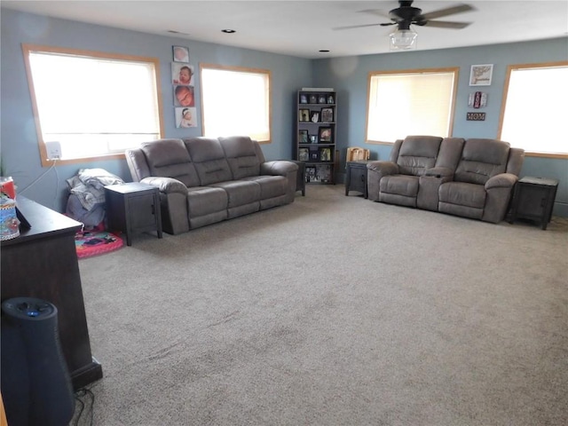 954 Monroe Ave, Tipton, IA 52772 - living area featuring ceiling fan, healthy amount of natural light, and carpet