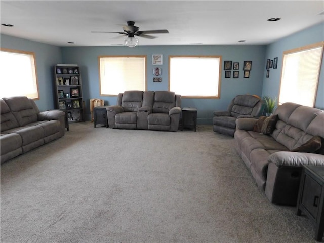 954 Monroe Ave, Tipton, IA 52772 - carpeted living area featuring a ceiling fan and plenty of natural light