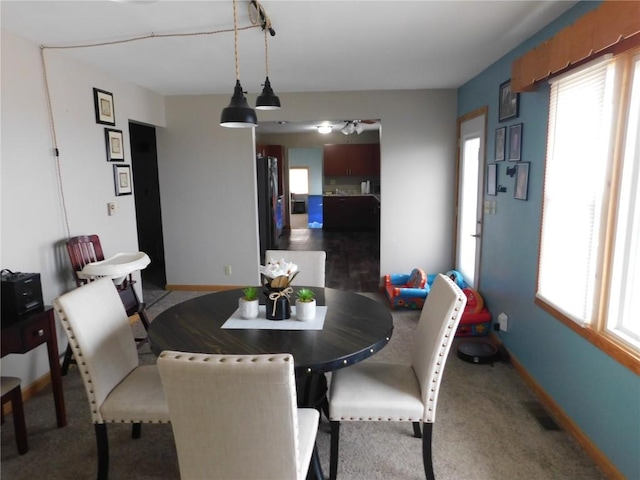 954 Monroe Ave, Tipton, IA 52772 - dining space featuring baseboards, a ceiling fan, and carpet flooring