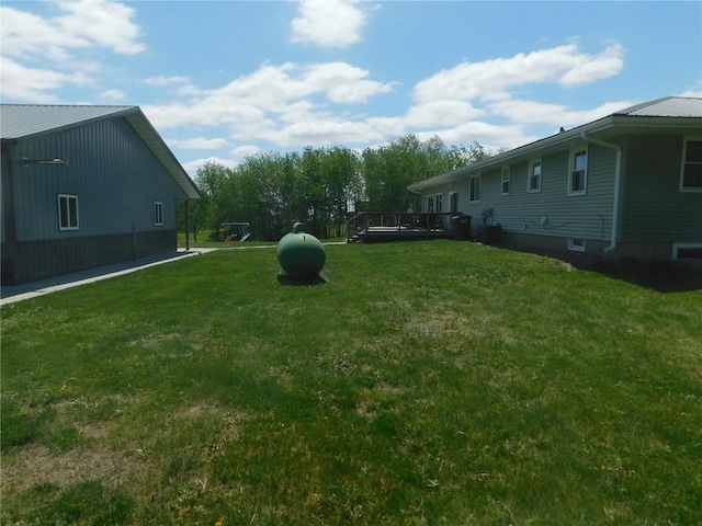 954 Monroe Ave, Tipton, IA 52772 - view of grassy yard with a deck