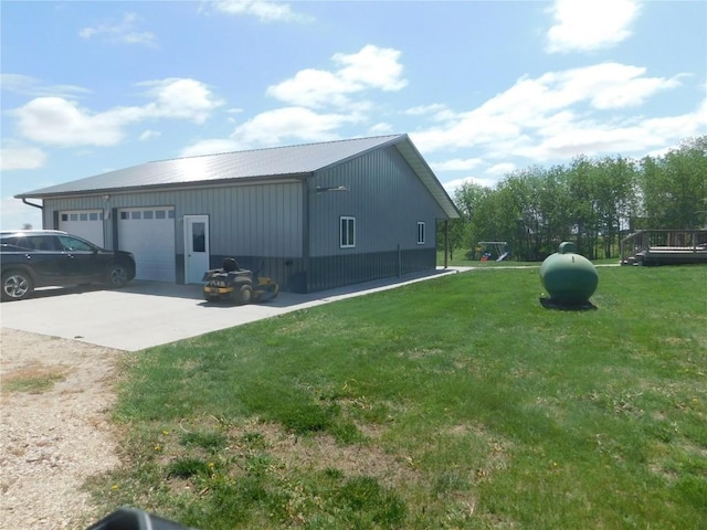 954 Monroe Ave, Tipton, IA 52772 - view of side of home with a lawn, a garage, and metal roof