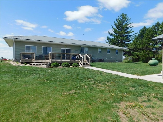 954 Monroe Ave, Tipton, IA 52772 - ranch-style home with a wooden deck, a front yard, and metal roof