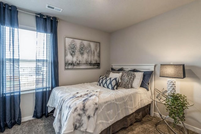 carpeted bedroom featuring visible vents and baseboards