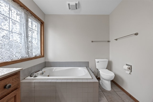 bathroom with visible vents, toilet, vanity, tile patterned flooring, and a bath