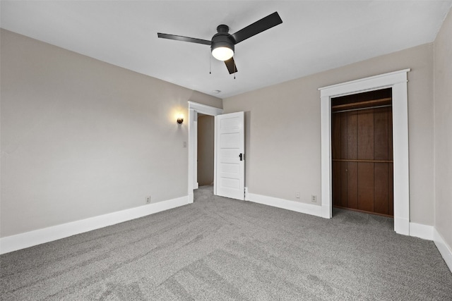 unfurnished bedroom featuring carpet floors, ceiling fan, baseboards, and a closet