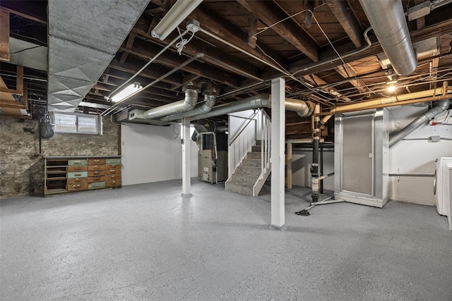 basement with stairway and heating unit