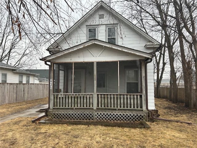 bungalow-style house featuring fence and a sunroom