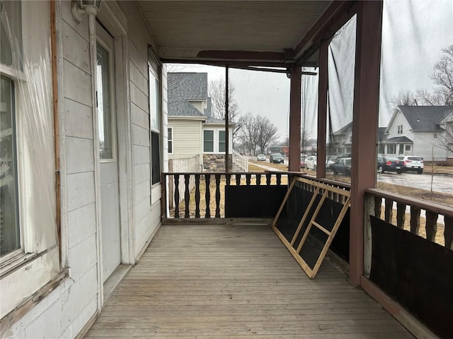 wooden deck with a porch and a residential view