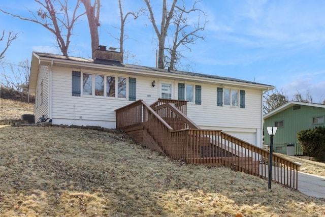 single story home with a garage, a chimney, and stairway