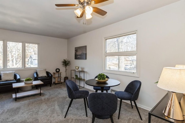 dining area featuring carpet, baseboards, and ceiling fan