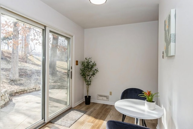 living area with light wood-style flooring and baseboards