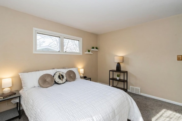 bedroom with carpet floors, baseboards, and visible vents