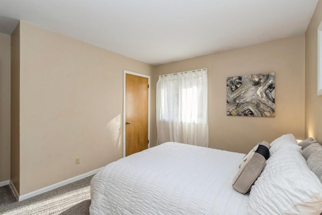 carpeted bedroom with baseboards