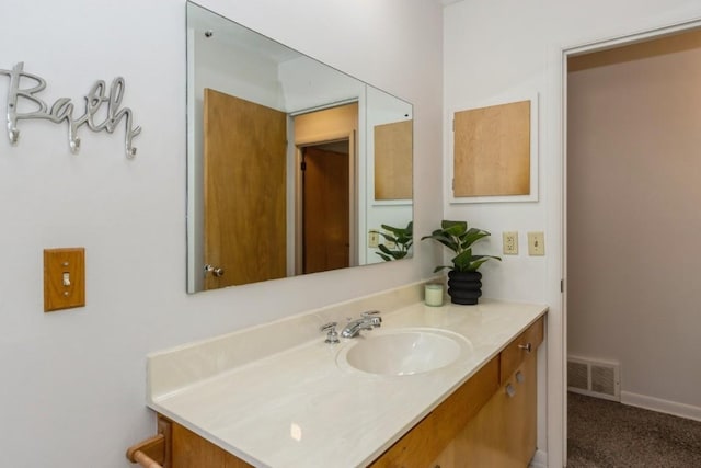 bathroom featuring visible vents, vanity, and baseboards