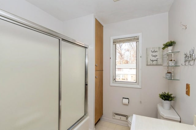 full bath with vanity, a shower with door, toilet, and baseboards