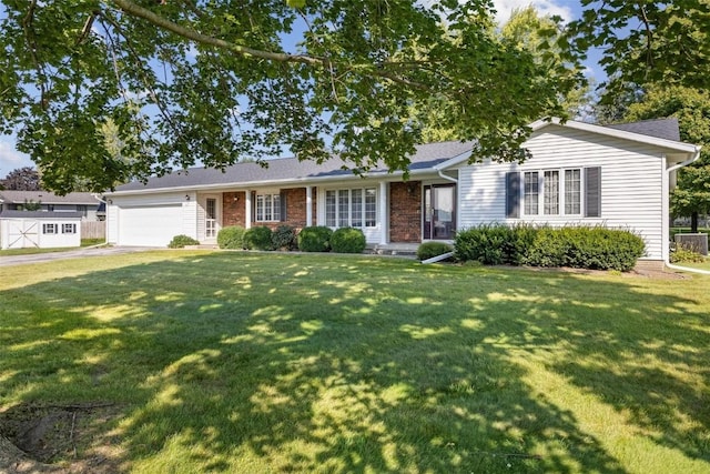 ranch-style house with a garage, a front yard, concrete driveway, and brick siding