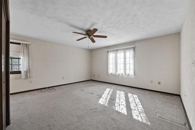 unfurnished room with ceiling fan, carpet flooring, and baseboards