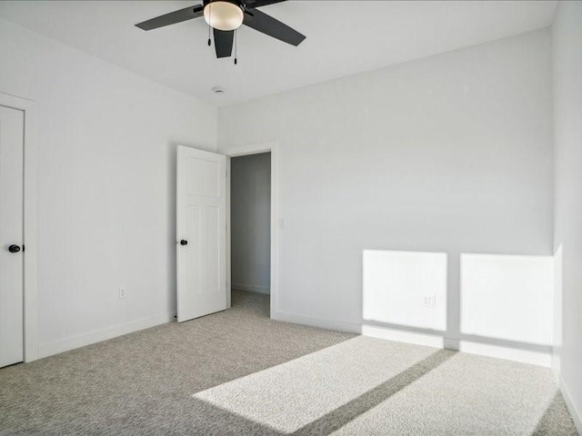 carpeted bedroom featuring baseboards and a ceiling fan