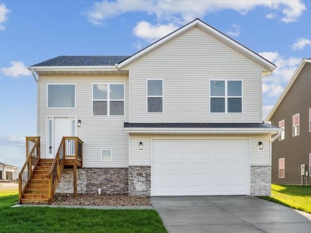 view of front of home featuring a garage, stone siding, driveway, and a front lawn