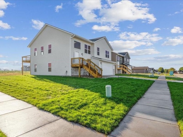 view of front of property with a garage, stairs, and a front yard