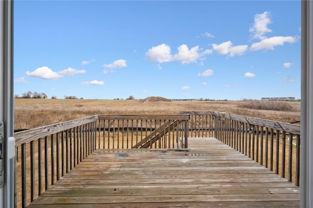 wooden deck with a rural view