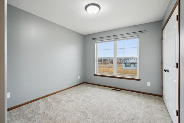 unfurnished bedroom with carpet floors, a closet, visible vents, and baseboards