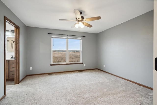 unfurnished bedroom featuring a sink, visible vents, baseboards, and carpet flooring