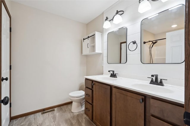 full bathroom with baseboards, visible vents, a sink, and toilet