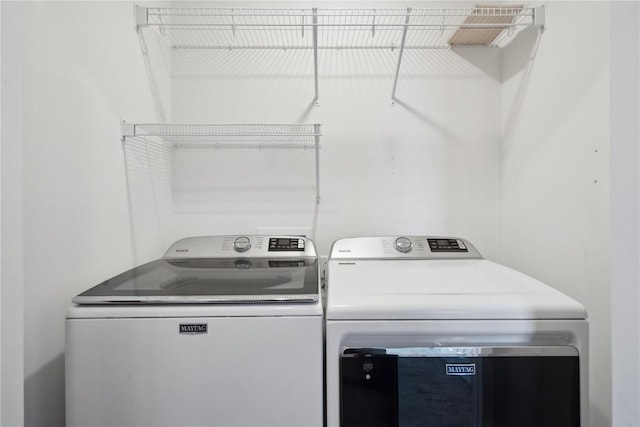 laundry area with laundry area and washing machine and clothes dryer