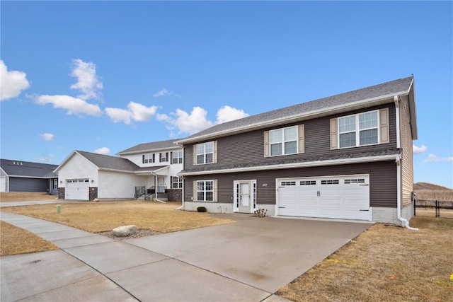 traditional-style home with a garage, driveway, and a front lawn