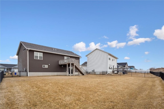 rear view of house with stairs, a yard, a deck, and a fenced backyard