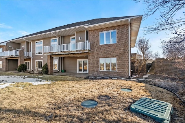 back of property featuring brick siding