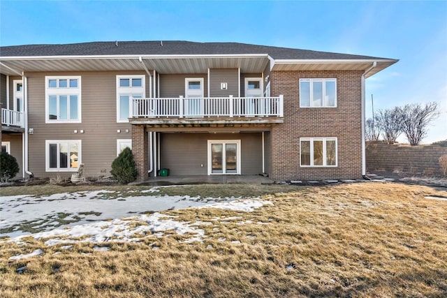 rear view of property with brick siding