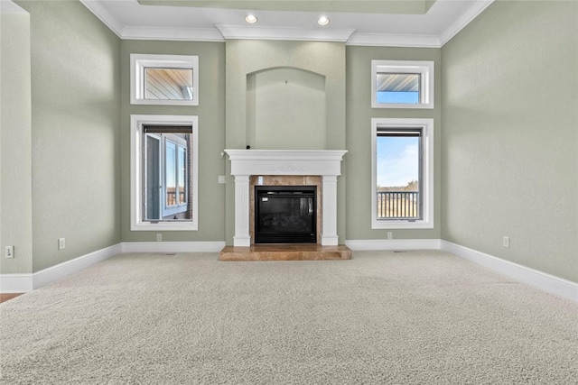 unfurnished living room with crown molding, a fireplace, recessed lighting, carpet flooring, and baseboards