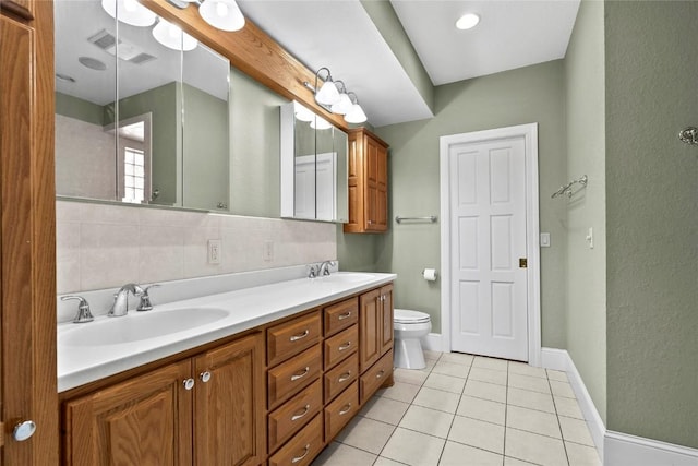 bathroom featuring tile patterned floors, visible vents, a sink, and double vanity