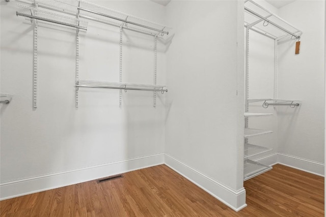 spacious closet with wood finished floors and visible vents